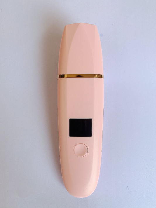 Ultrasonic Skin Scrubber pink front view on grey surface – LCD display with gold trim and single button control for Cleansing Moisturising and Lifting modes